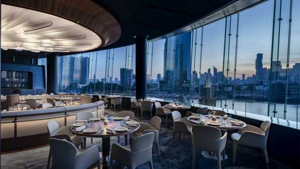 Cream banquettes and chairs, unadorned wooden tables echoing the wooden floor adds to the sensory smorgasbord